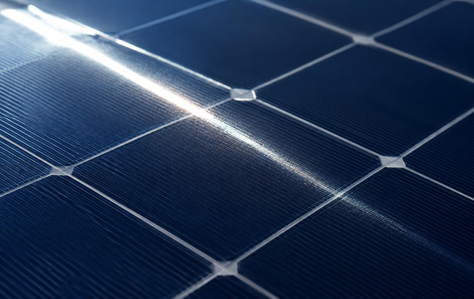 Superficie de un panel fotovoltaico con un reflejo de luz